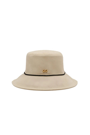 Beige bucket hat with a black band and gold accents on a white background