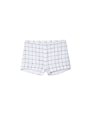 White shorts with black grid pattern on a gray background