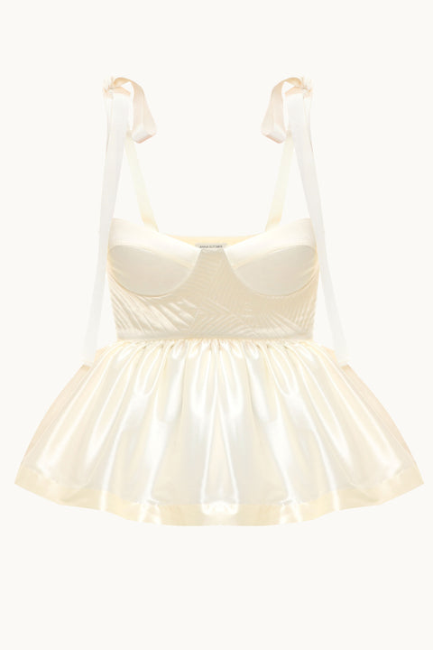 Front view of the ivory bustier peplum top with shoulder ties  for straps.