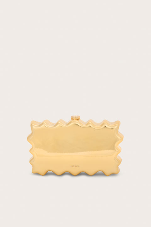 A metallic gold rectangular, acrylic clutch that features a wavy perimeter design and gold hardware. 