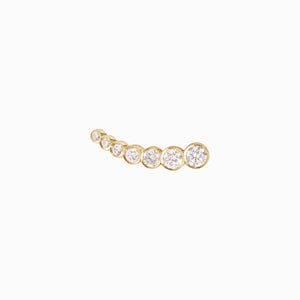 Gold earring with diamonds in a slight curve on a white background