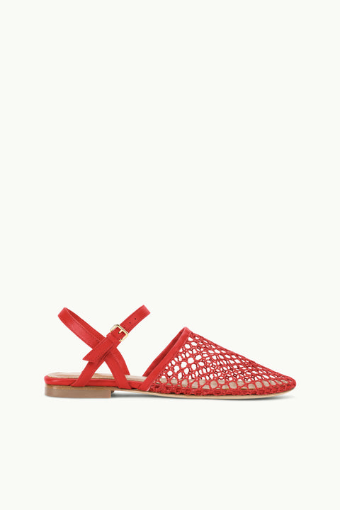 Side profile of a red, closed-toe, mesh flat sandal that features criss-cross ankle straps.