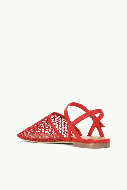 Back view of a red, closed-toe, mesh flat sandal that features criss-cross ankle straps.