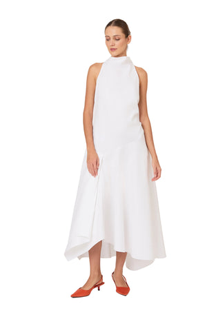 Woman wearing a white midi dress with a halter neck design on a white background