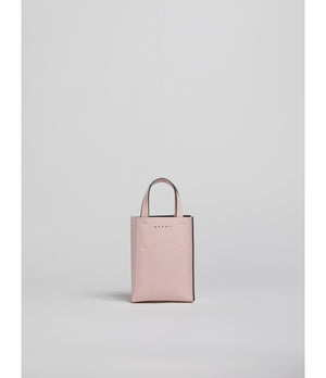 Pink leather nano tote with top handles.