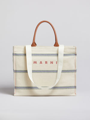 Marni medium tote in cream with blue stripes and brown leather straps.