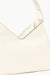 Close up of the back of the cream leather shoulder bag with the STAUD logo