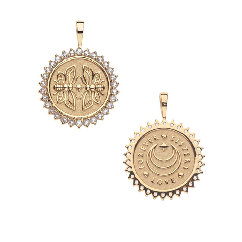 Gold coin pendant with a front that depicts two twin bees surrounded by white topaz stones and a back that is inscribed with FOREVER - SISTERS - LOVE