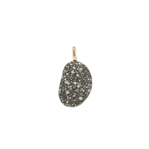 A black and white speckled stone pendant that is accented by small round diamonds and set with a gold bail. 