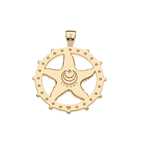 Back of Gold pendant with 'strong' etched on, on a white background