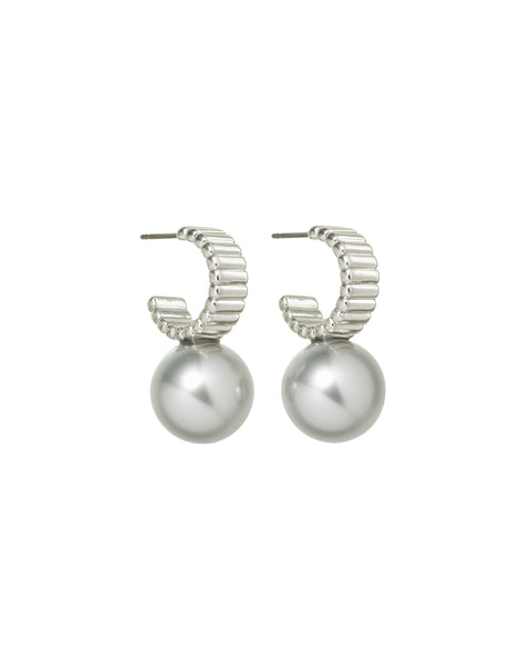 A pair of silver hoop earrings that feature a ribbed design and a polished silver ball below the hoop. 