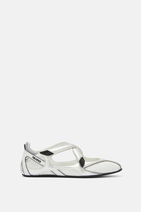 Side profile of a ballerina flat crafted from a textured, white fabric and silver trim, featuring two crisscross top straps and a subtle logo embossed on the heel. 