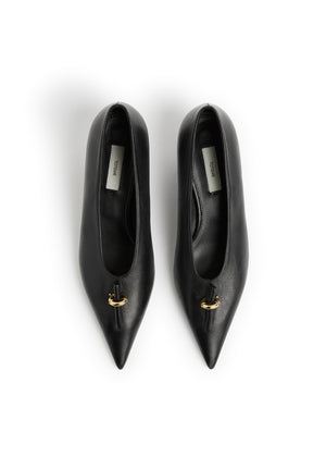 A pair of black leather pointed-toe pumps with a small gold detail on the vamp, photographed from directly above on a white background.