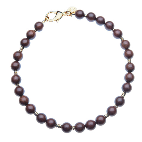 A necklace with round, wooden beads, accented by gold filler beads. 