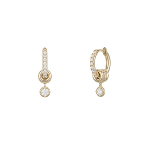 Ghost image of 18k yellow gold mini hoop earring that is pave with white diamonds and features three 18k gold annulets, one with a dangling white diamond charm. 