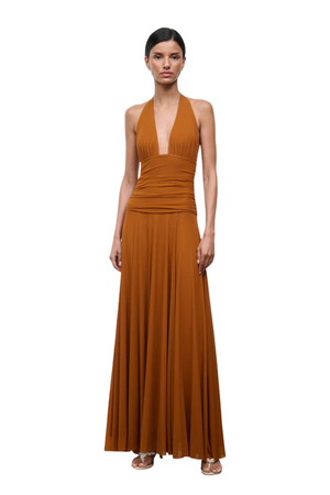 Woman wearing a long brown dress on a white background