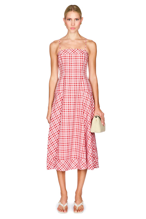 Woman wearing a red and white checkered dress on a white background
