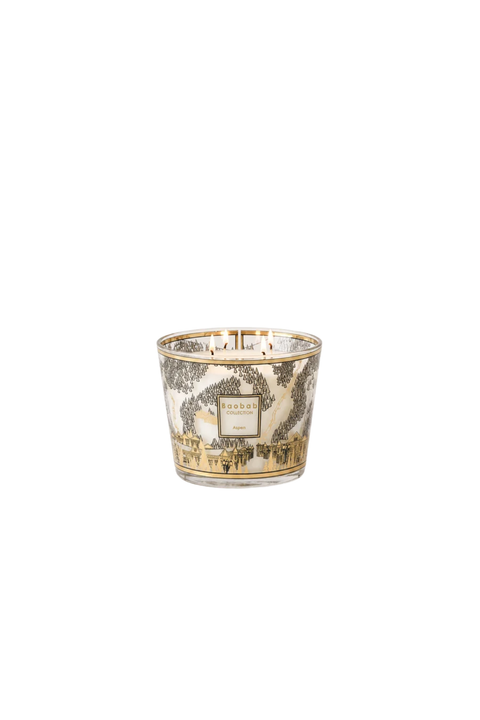 Small four-wick candle with mountain ski scene on vessel. 