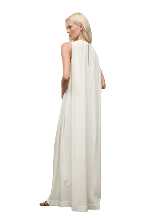 Woman wearing a long white dress on a white background