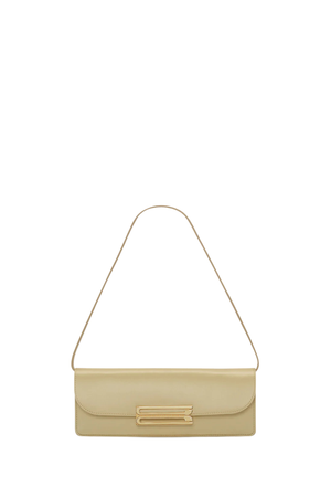 A light beige leather shoulder bag with a thin matching strap and a gold-tone metal accent on the front flap, shown against a plain white background.
