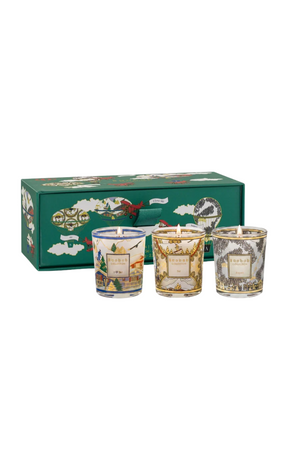 A set of three decorative glass jar candles displayed in front of their matching green gift box, which features vintage-style travel illustrations.