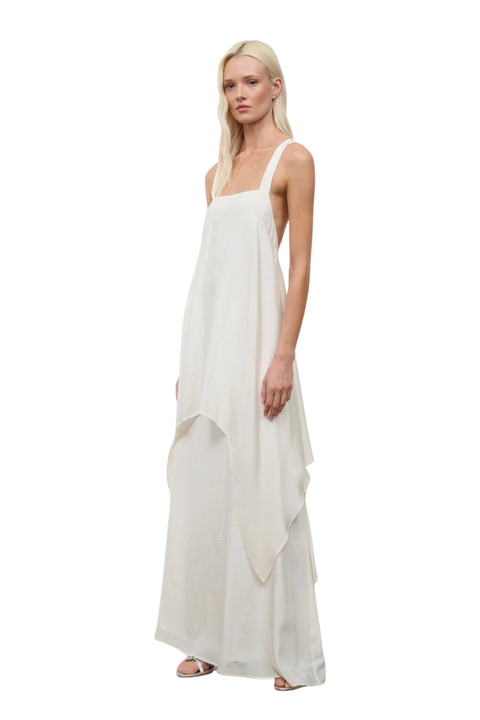 Woman wearing a long white silk dress on a white background