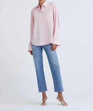 Model wearing the wesley button up shirt in light pink.