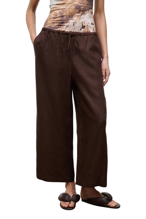 Close-up of a woman wearing brown drawstring wide-leg pants