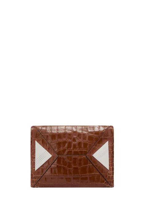 The bottom of a brown croc handbag