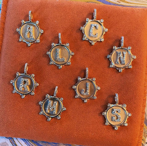 Image of different charms displaying different letters
