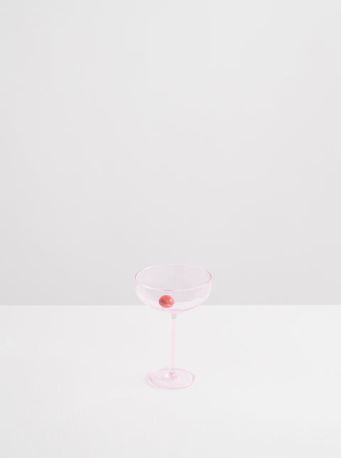 Opaque pink Maison Balzac Manhattan glass with a glass cherry.