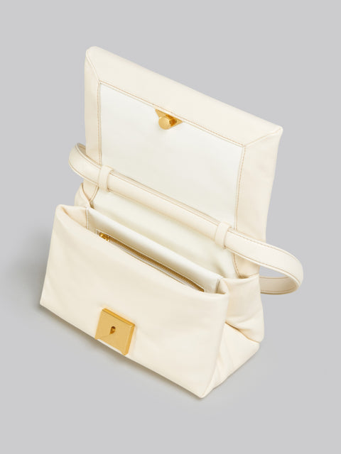 Ivory leather bag opened to show the inside